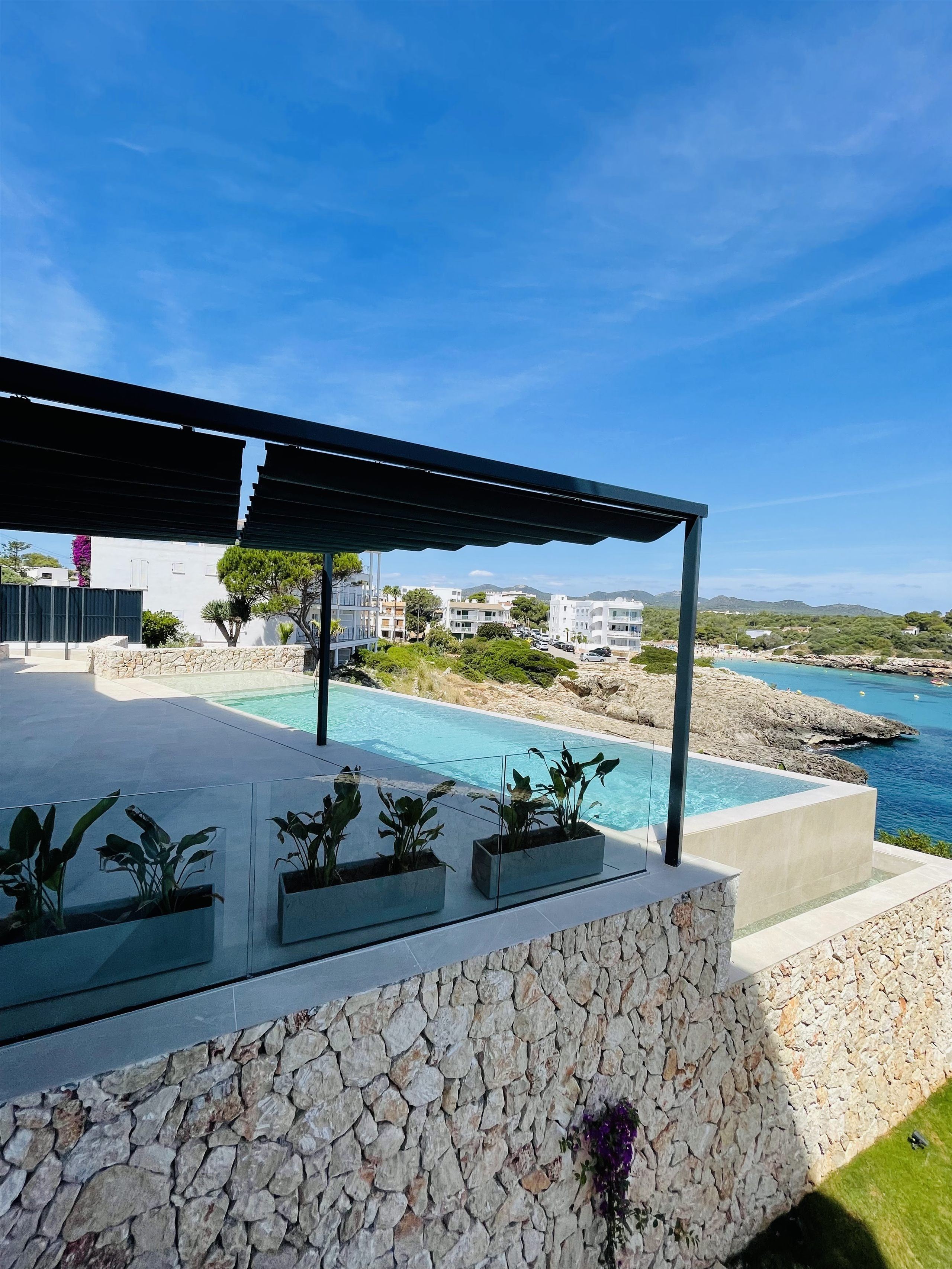 Blick von der Pergola über den Pool auf die Bucht